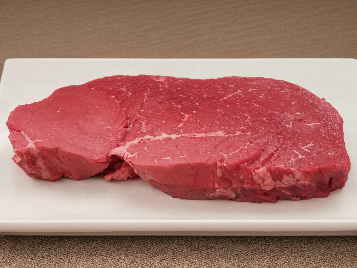 Raw top round London broil from local farm raised cattle