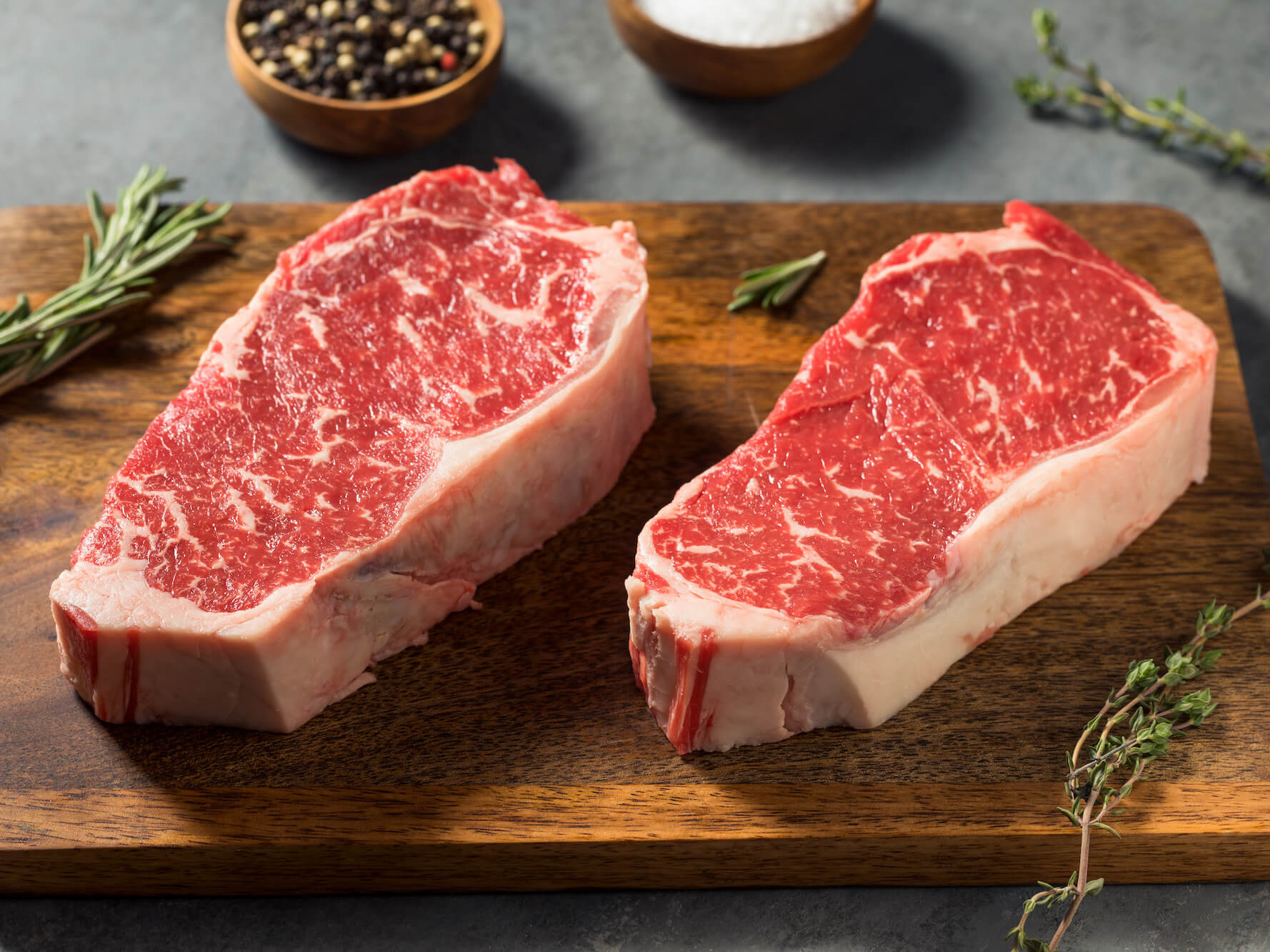 Raw New York strip steak from local farm raised cattle