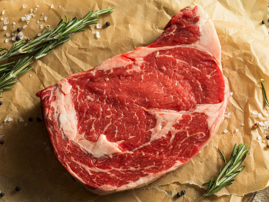 Raw ribeye steak from local farm raised cattle